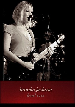 Photo of Brooke Jackson on lead vocals performing onstage.