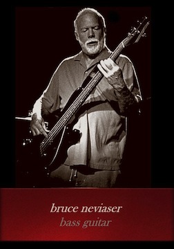 Photo of Bruce Neviaser on bass guitar performing onstage.